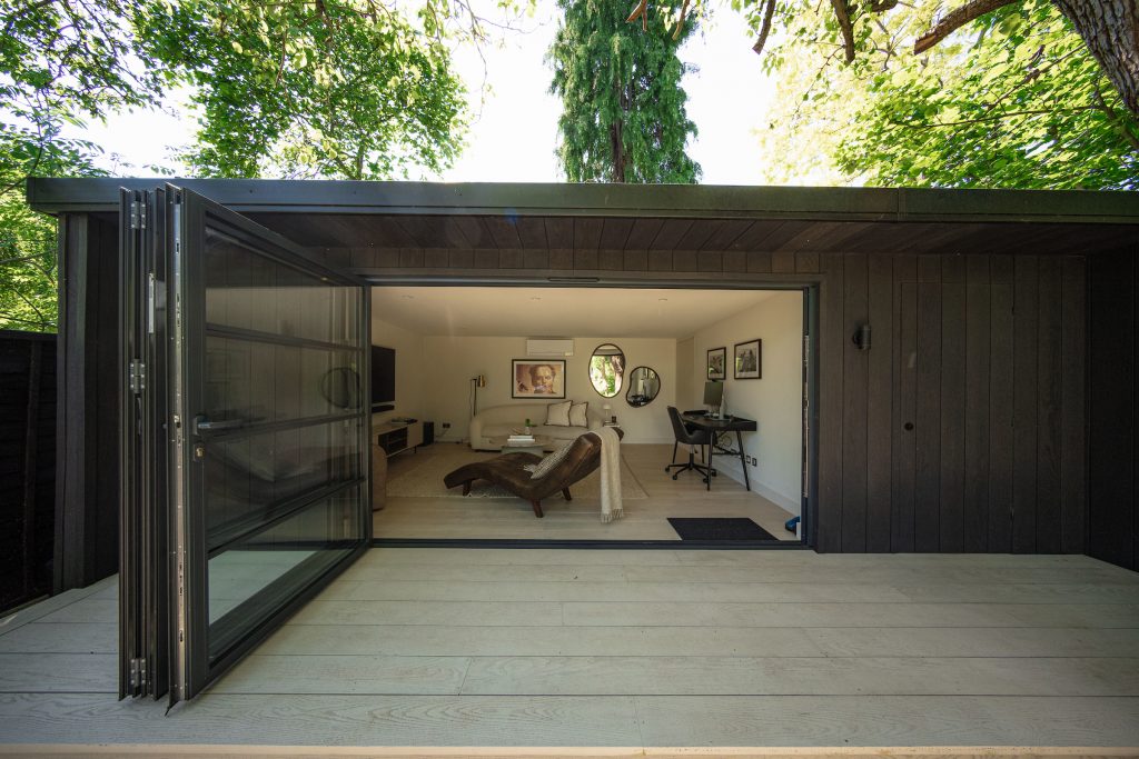 Wooden garden room with office space and large sofa