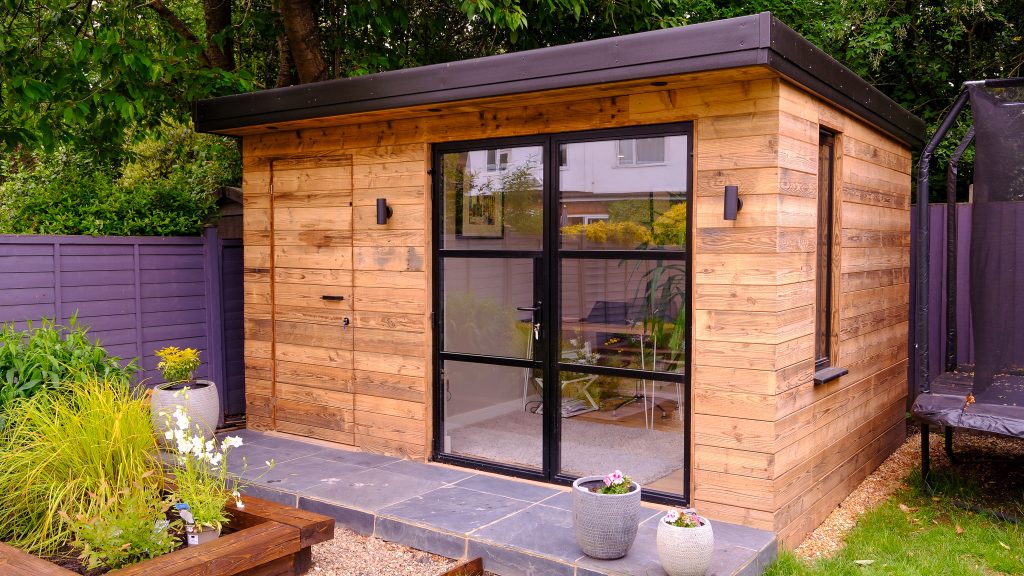 Wooden garden room with office setup