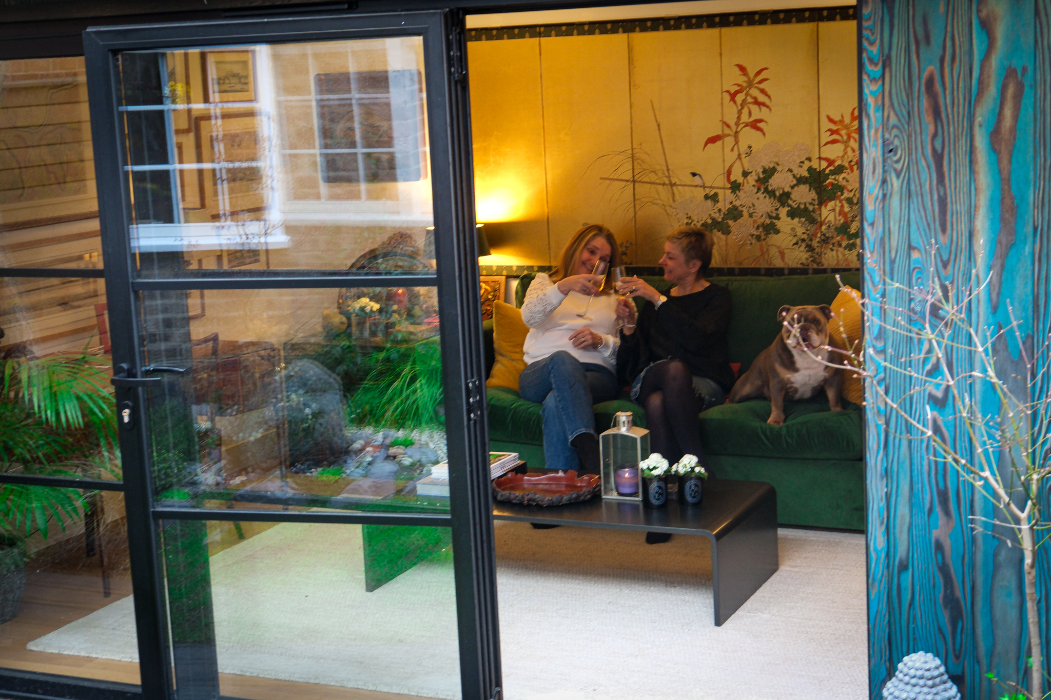 Family relaxing together in a garden family room by Into The Garden Room