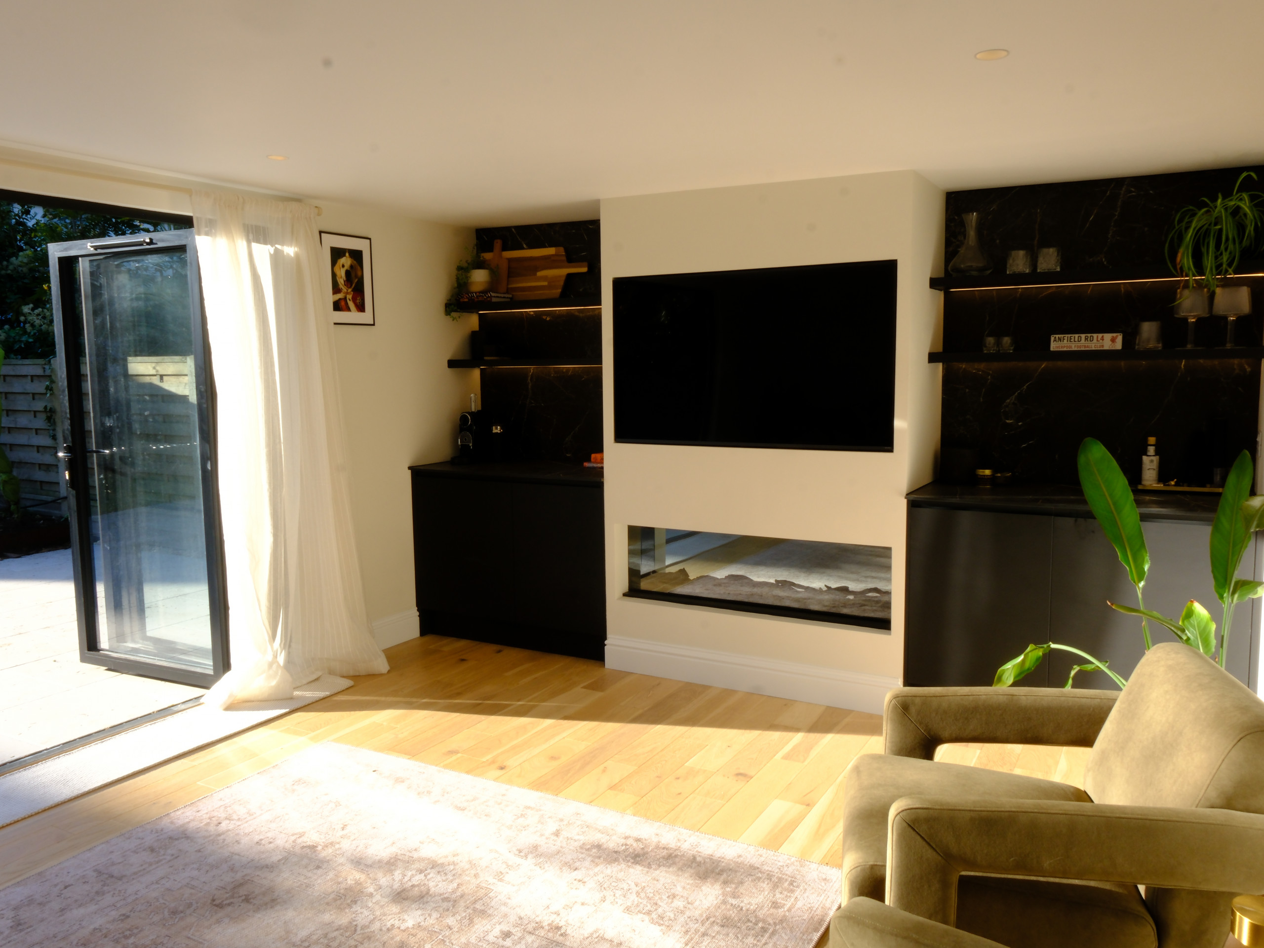 Garden family room with media wall and lounge seating by Into The Garden Room