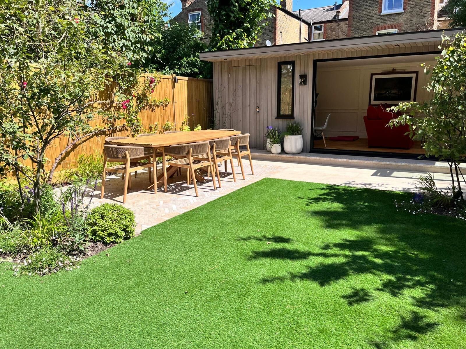 Bespoke garden building integrated with landscaping by Into The Garden Room
