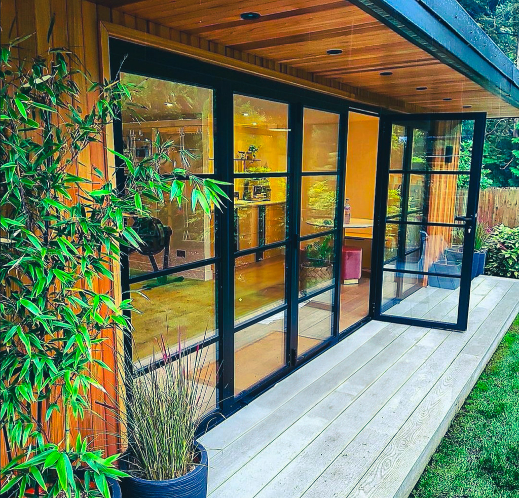 Modern timber-clad garden room with glazed doors